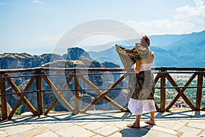 Woman is wearing a skirt and scarf in Meteora Monastery